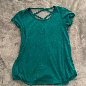 teal shirt with criss-cross design on the back.
